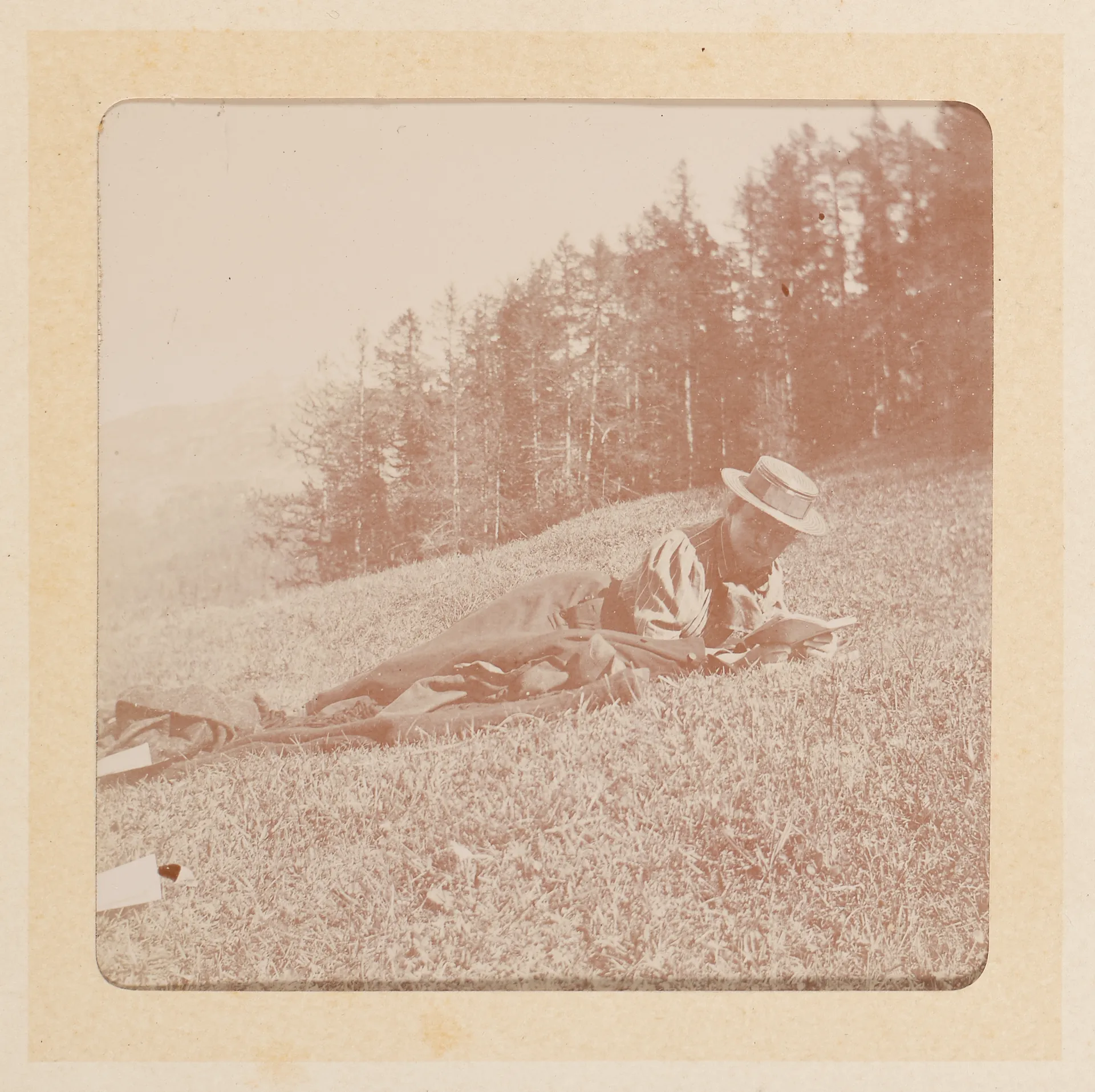 Ottilie W. Roederstein auf einer Wiese lesend